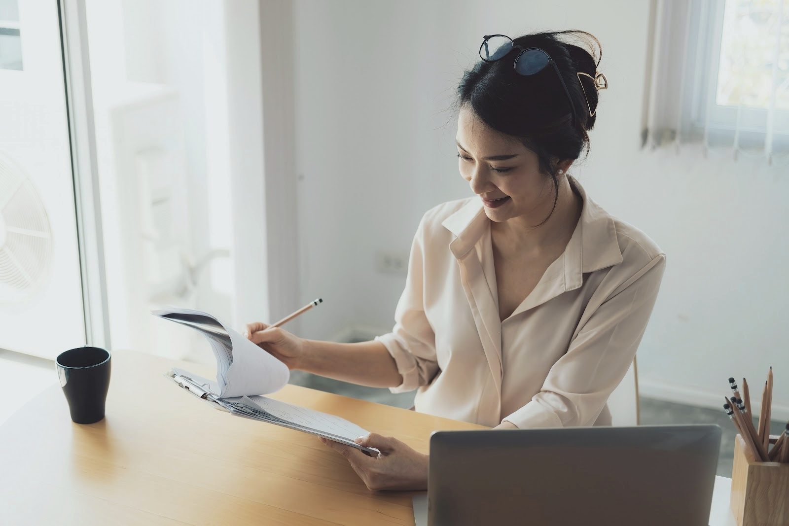 A staff member works through insurance paperwork at a desk
